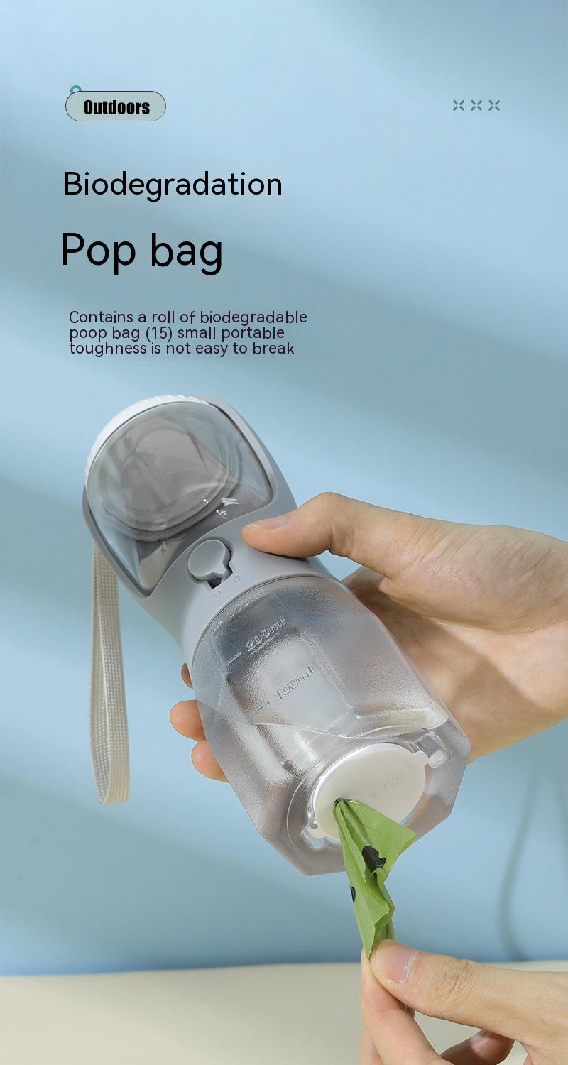Biodegradable poop bag dispenser held by a hand with a light blue background